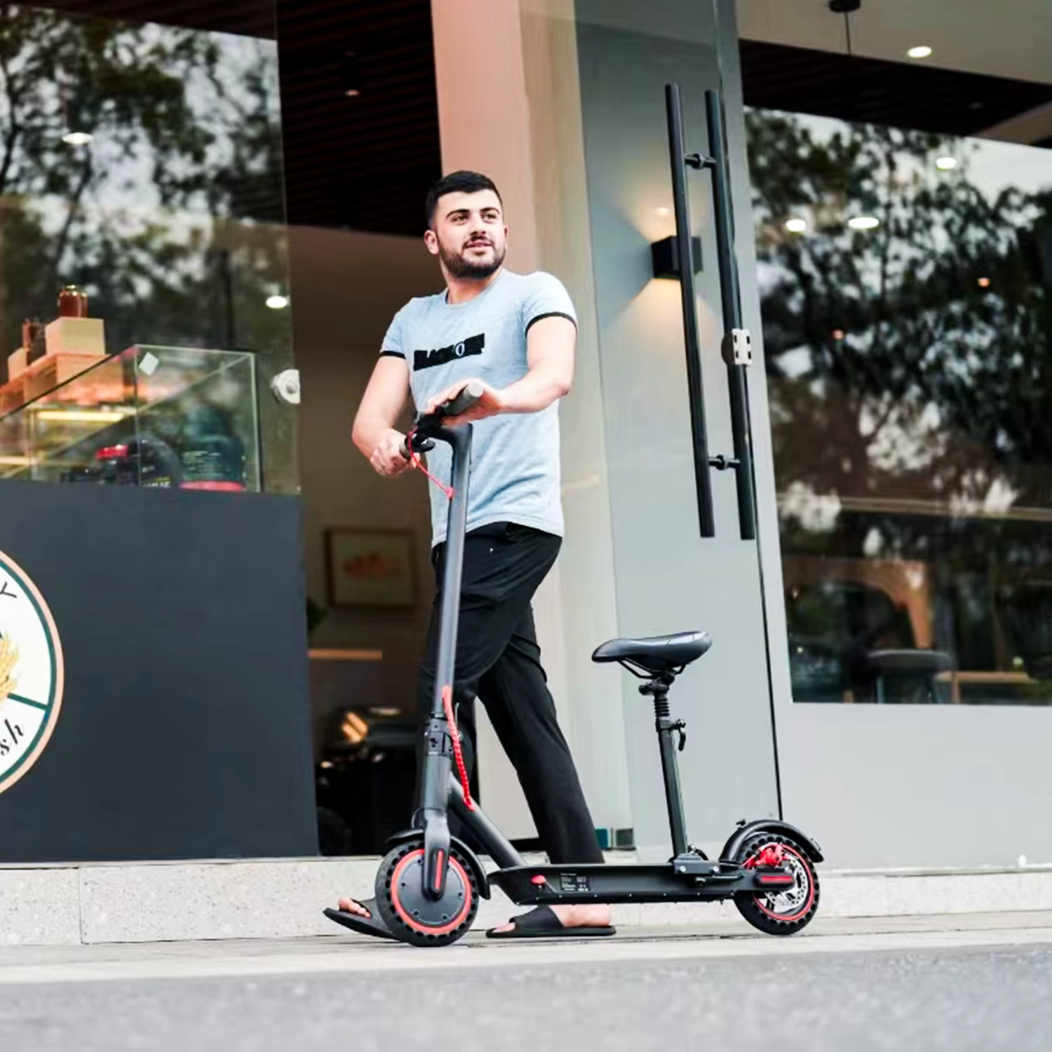 Rider pausing with the Khuzana electric scooter outside a café